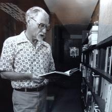 Don searching in book from his shelves